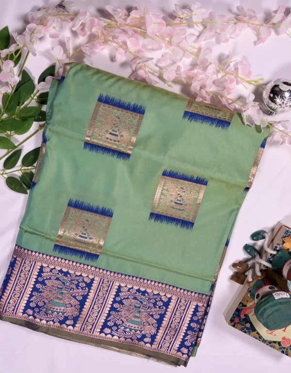 mint green baluchori silk saree with royal blue dancing motif border